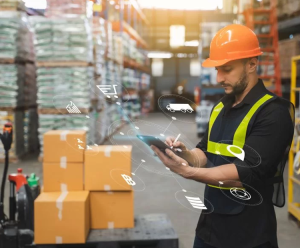 man in a warehouse working on a tablet